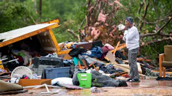 Sylvia Salley looks at the remains of her sisters storm damaged home Monday in Livingston, SC. A string of storms caused more than a dozen deaths across the southern United States.