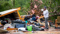 Sylvia Salley looks at the remains of her sisters storm damaged home Monday in Livingston, SC. A string of storms caused more than a dozen deaths across the southern United States.