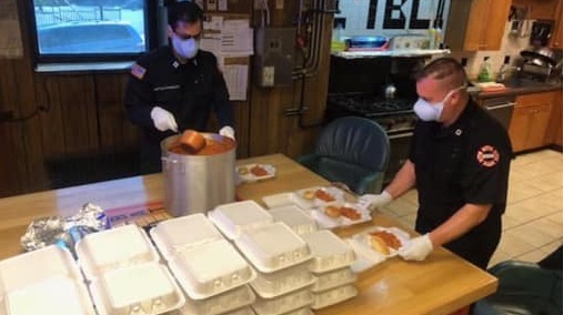Newark, NJ, firefighter Stephen Wolf (right) and Capt. Claudino Dominguez prepare food for senior citizens. Wolf recently lost his 73-year-old mother to the coronavirus.