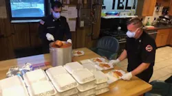 Newark, NJ, firefighter Stephen Wolf (right) and Capt. Claudino Dominguez prepare food for senior citizens. Wolf recently lost his 73-year-old mother to the coronavirus.