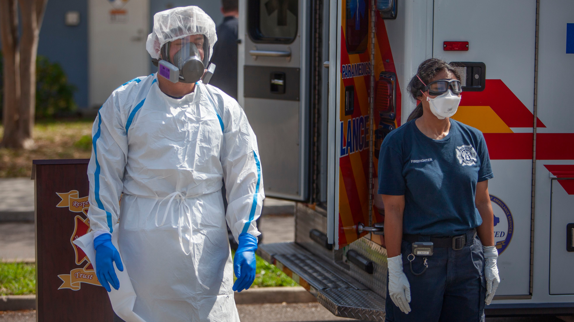 Firefighter/Paramedic William Fletcher Firefighter/Paramedic William Fletcher (left) wears COVID-19 personal protective equipment and EMT Mya Jones wears basic level personal protective equipment during a press conference March 31 in the parking lot of Northwest Community Pool in St. Petersburg, FL. St. Petersburg Fire Rescue, in partnership with Sunstar Paramedics, has developed a strategy to deploy COVID-19 Strike Teams.