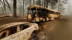 Burned vehicles line the escape route out of Paradise, CA, in the aftermath of the Camp Fire in November 2018.