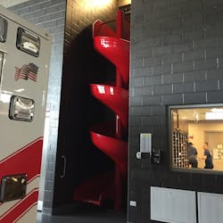 A non-traditional slide for firefighters to quickly descend from the second floor to the apparatus bay. A non-traditional slide for firefighters to quickly descend from the second floor to the apparatus bay.