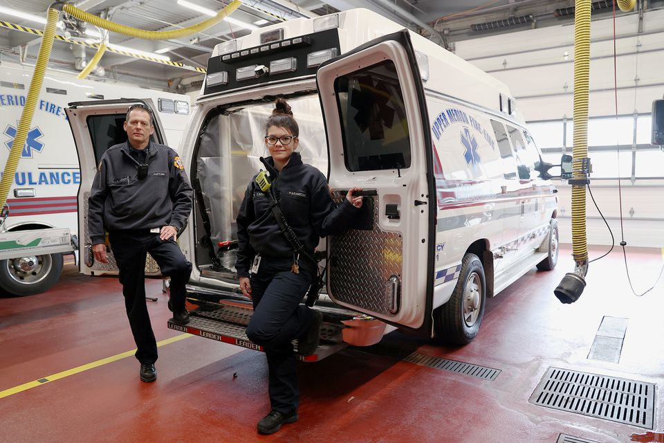 Capt. Keith Ledger, left, and parademic Megan Carr at one of their ambulances used to transport coronavirus patients at the Upper Merion Fire and EMS station in King of Prussia, Pa.