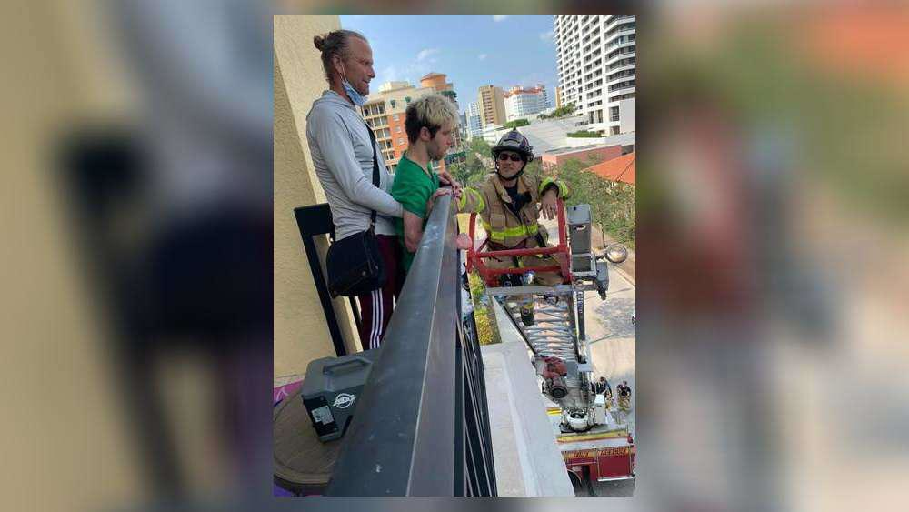 West Palm Beach Lt. Brett Koning is at the tip of the aerial to greet Korey Soderman and his family.