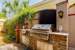 A backyard kitchen includes a fire alarm box and fire hydrants.
