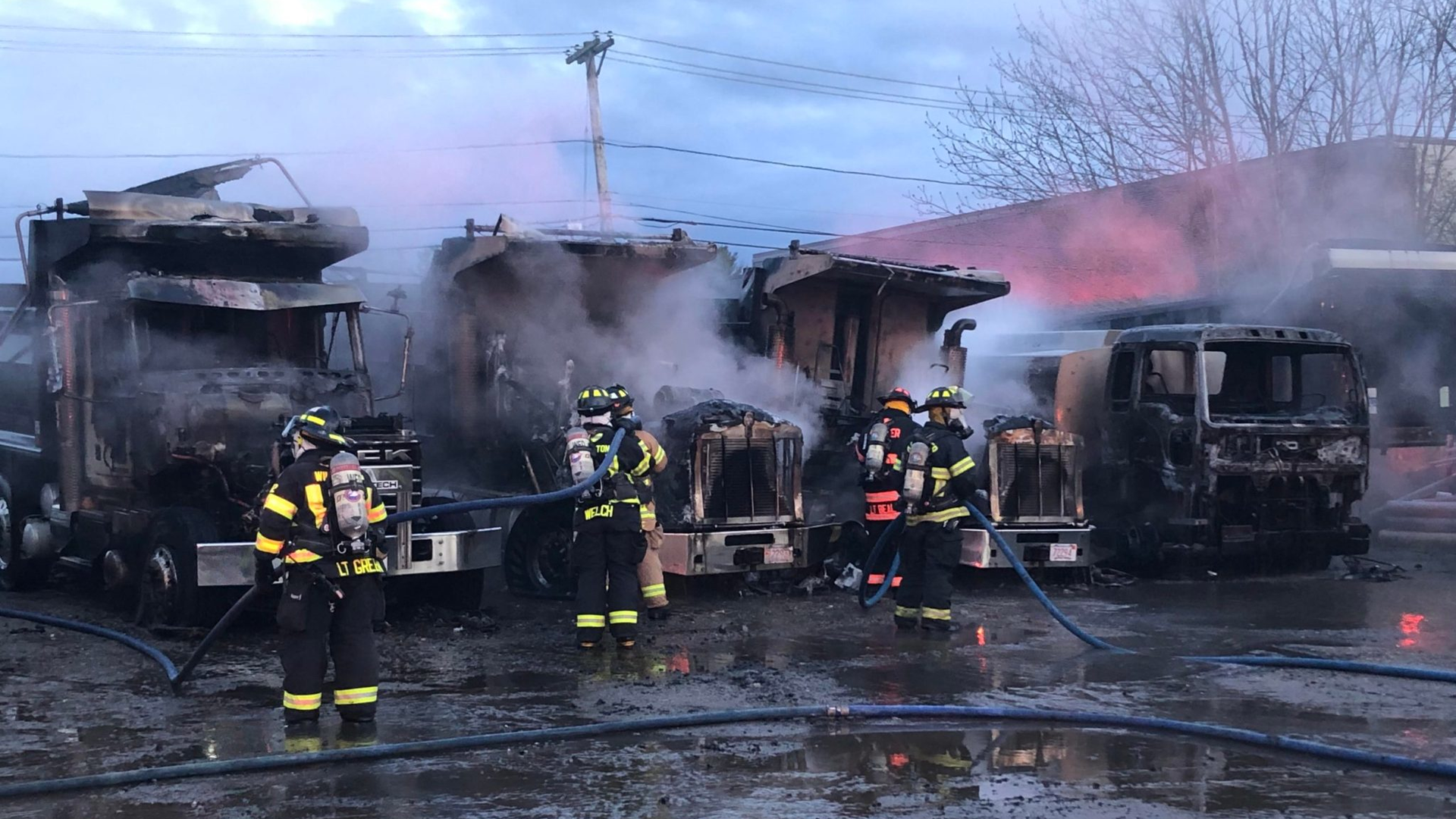 Firefighters from Andover, MA, and other departments Andover Fire Rescue extinguished a blaze involving four dump trucks and an oil tanker Friday.