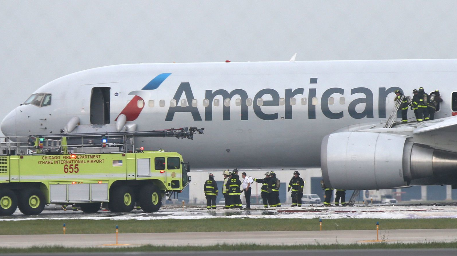 Firefighters extinguish flames from an American Airlines plane on a runway at Chicago's O'Hare International Airport in 2016.