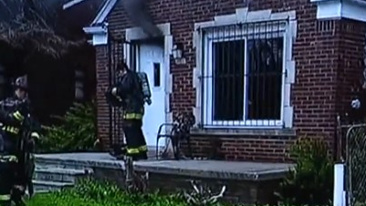 Detroit firefighters kicked down a door to rescue two boys inside a burning house Saturday.