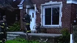 Detroit firefighters kicked down a door to rescue two boys inside a burning house Saturday.