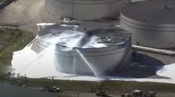 Firefighters used foam to extinguish a blaze that broke out following the explosion of an oil storage tank near the Texas A&M University Galveston campus Tuesday.