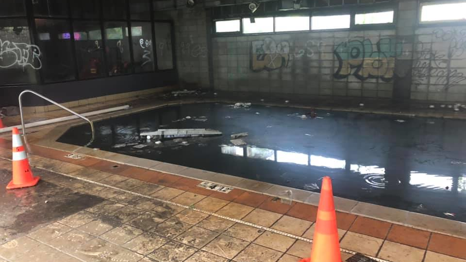 Two Joplin, MO, firefighters escaped injury after falling into a swimming pool filled with rancid water while battling a blaze at a vacant hotel Friday.