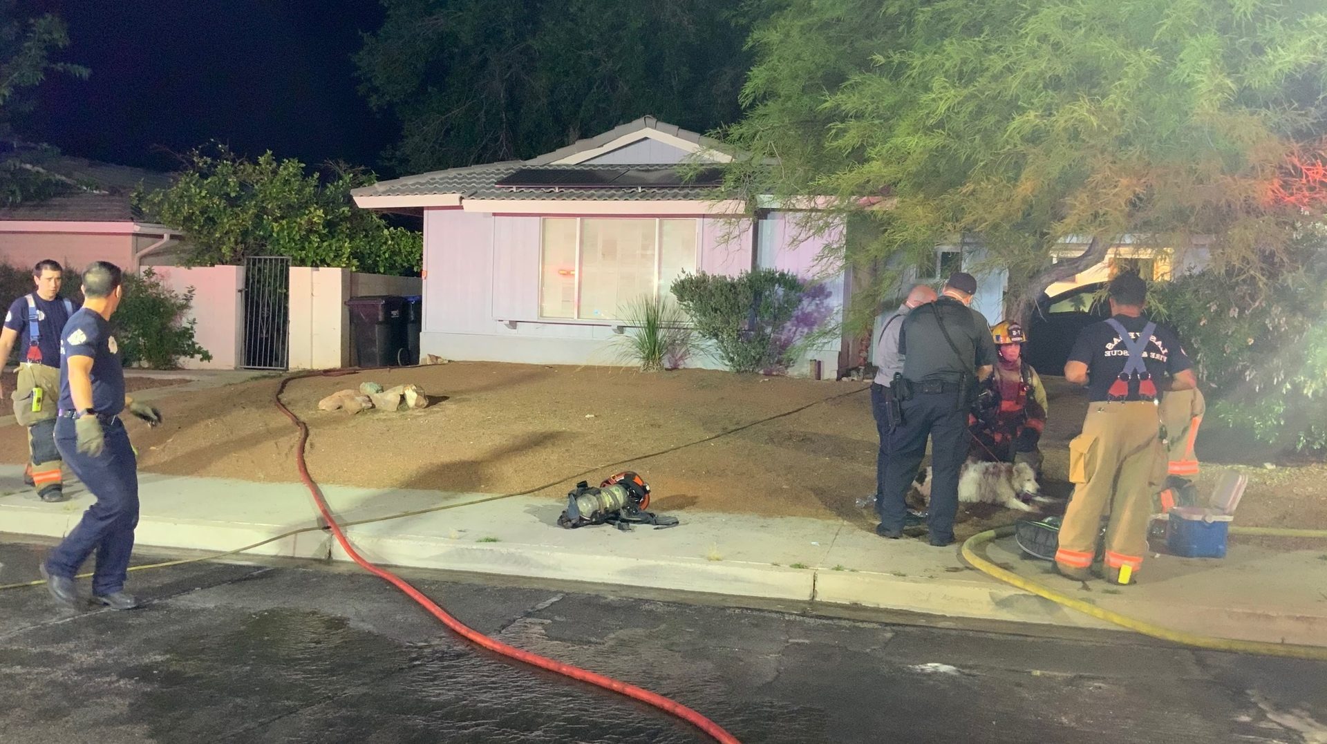 Las Vegas firefighters rescued a woman and a dog from a burning one-story house Thursday night.