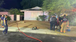 Las Vegas firefighters rescued a woman and a dog from a burning one-story house Thursday night.
