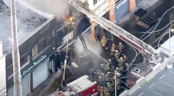 Firefighters work to put out a large commercial fire in downtown Los Angeles that injured 11 firefighters and left multiple buildings ablaze Saturday.
