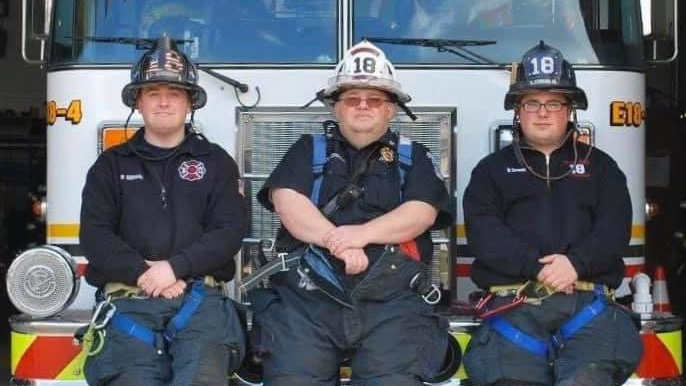 Assistant Fire Chief Robert E. Zerman sits between his firefighter sons Robert J. and Brandon in this undated photo.