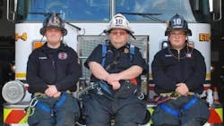 Assistant Fire Chief Robert E. Zerman sits between his firefighter sons Robert J. and Brandon in this undated photo.