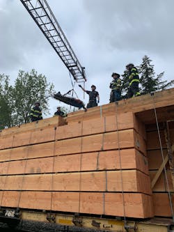 After the man was pulled out from the lumber, he was brought down to safety with an aerial ladder. After the man was pulled out from the lumber, he was brought down to safety with an aerial ladder.