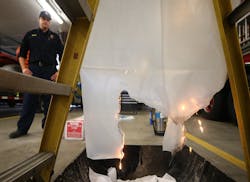 Coventry Township Fire Lt. Brian Cyphert watches as a plastic shower curtain burns and melts. Coventry Township Fire Lt. Brian Cyphert watches as a plastic shower curtain burns and melts.