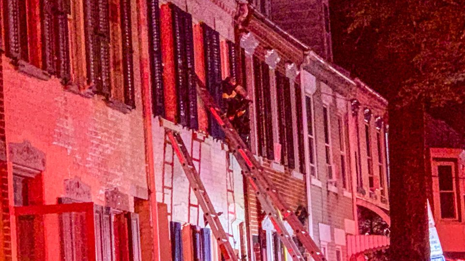 A firefighter and a resident were injured during a three-alarm blaze that broke out in a set of Allentown, PA, row houses Sunday.