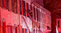 A firefighter and a resident were injured during a three-alarm blaze that broke out in a set of Allentown, PA, row houses Sunday.