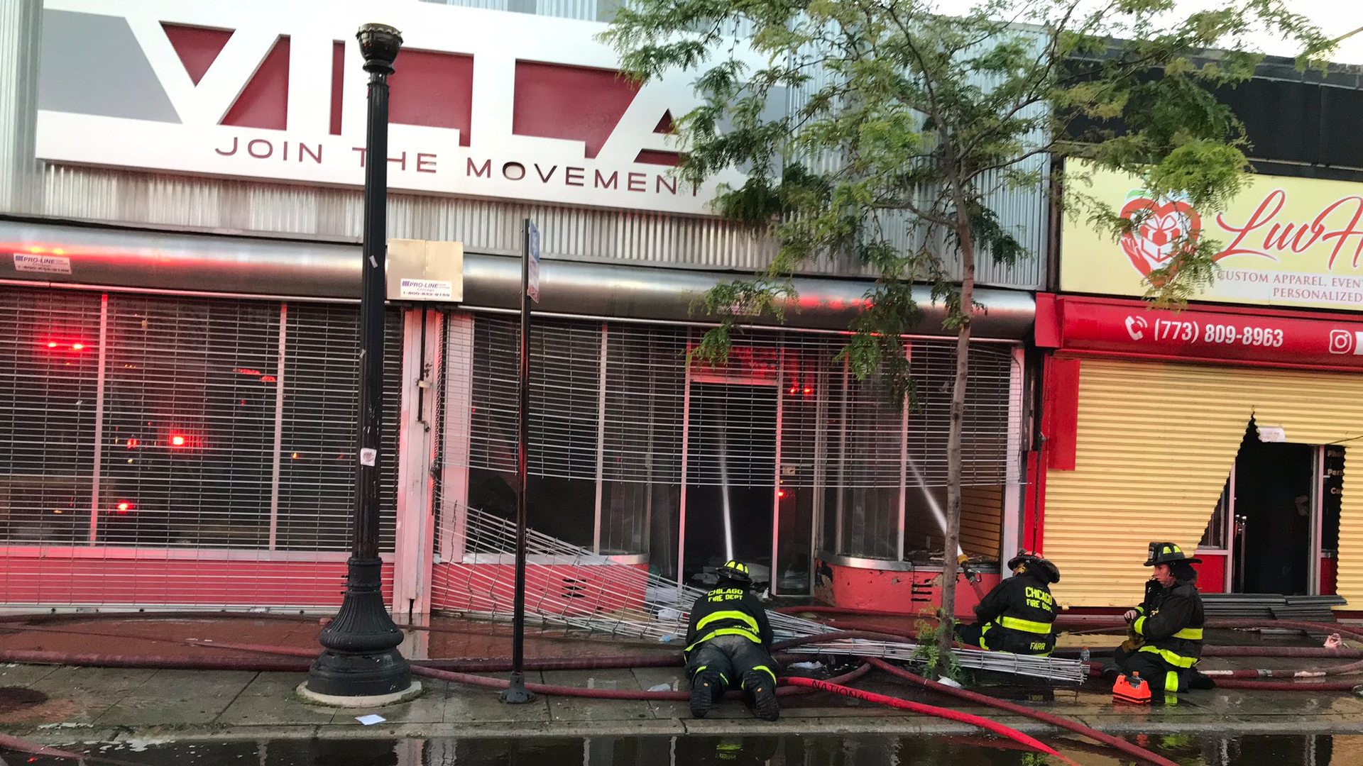 A Chicago firefighter was injured when the ceiling collapsed during a two-alarm blaze at a strip mall in the city's Grand Boulevard area Sunday.