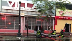 A Chicago firefighter was injured when the ceiling collapsed during a two-alarm blaze at a strip mall in the city&apos;s Grand Boulevard area Sunday.