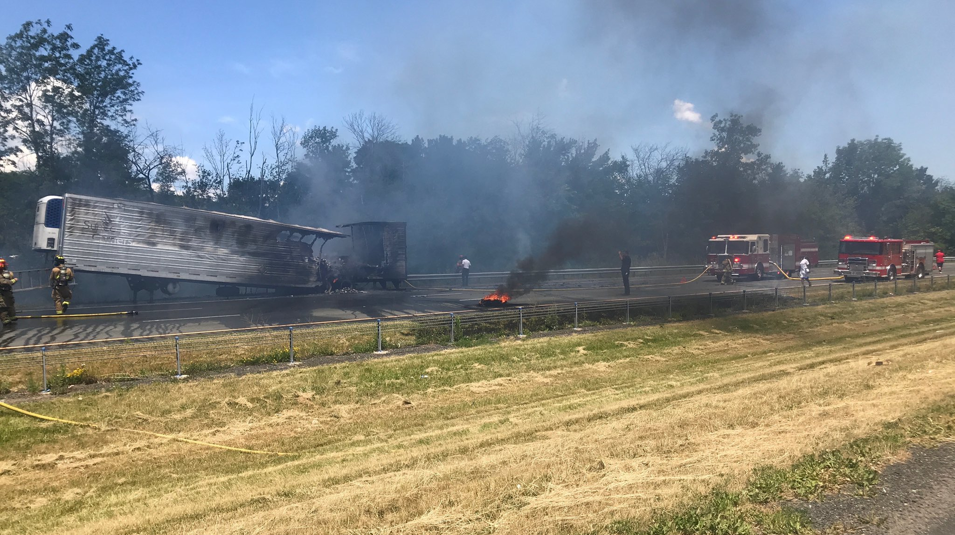 West Springfield, MA, and Holyoke firefighters battle a tractor-trailer blaze along Interstate 91 Sunday that sent a firefighter to the hospital after a driver plowed into the back of a police cruiser that then struck a firefighter.