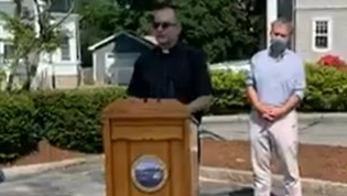 Firefighters from then New Bedford, MA, and Fall River fire departments honored their chaplain, the Rev. Michael Racine (center), with a surprise thank-you event Wednesday.