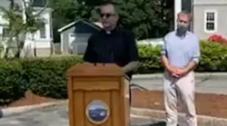 Firefighters from then New Bedford, MA, and Fall River fire departments honored their chaplain, the Rev. Michael Racine (center), with a surprise thank-you event Wednesday.