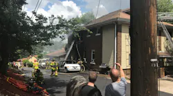 A Pittsburgh firefighter was injured battling a blaze that began in a vehicle and spread to a duplex Monday.