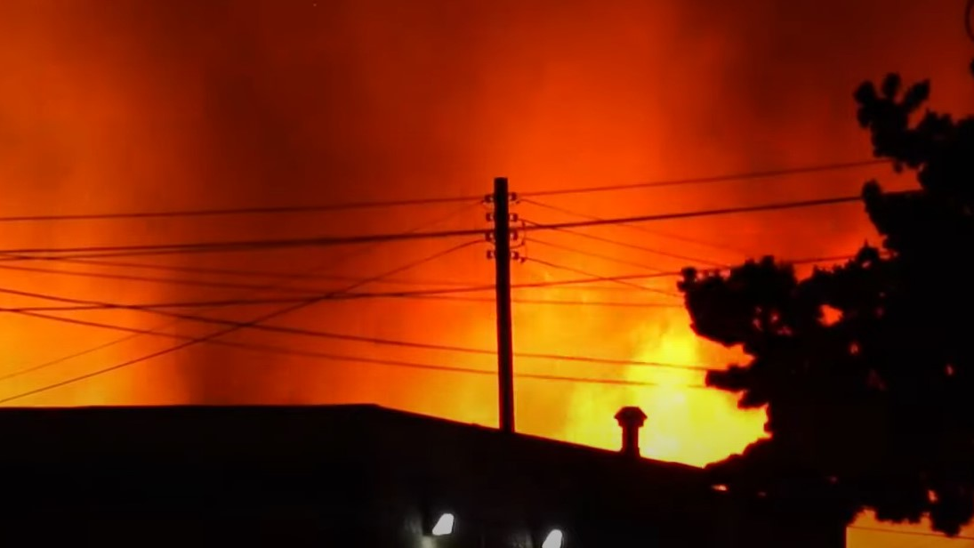 More than 200 firefighters battle a five-alarm blaze late Monday that had flames engulfing a pallet yard and three adjacent businesses.