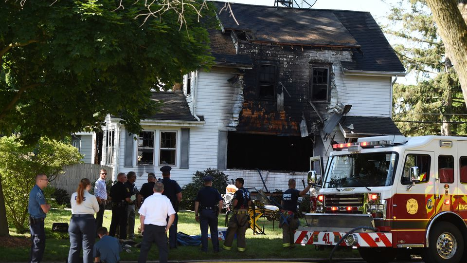Firefighters from multiple departments and other emergency personnel at the scene of a fatal house fire in Jackson, MI, on June 6, 2020.