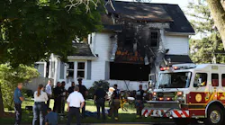 Firefighters from multiple departments and other emergency personnel at the scene of a fatal house fire in Jackson, MI, on June 6, 2020.
