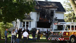 Firefighters from multiple departments and other emergency personnel at the scene of a fatal house fire in Jackson, MI, on June 6, 2020.