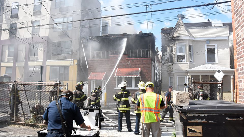 North Hudson Regional Fire and Rescue members respond to a three-alarm fire Wednesday on 54th Street in West New York, NJ.