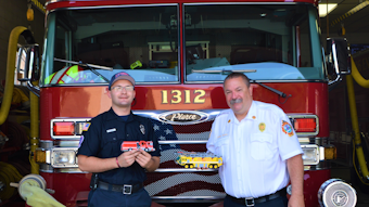 Jeffrey Braun (left), who is a firefighter/EMT-B for the Lyons, IL, Fire Department (LFD), with LFD Fire Chief Gordon Nord, Jr., who is holding one of two airport rescue firefighting vehicles (AARF) that Braun built from Lego blocks. Braun is holding the replica that he built of the Alsip, IL, Fire Department&rsquo;s Engine 2063, which he made for that department&rsquo;s chief.