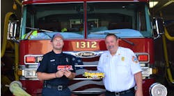 Jeffrey Braun (left), who is a firefighter/EMT-B for the Lyons, IL, Fire Department (LFD), with LFD Fire Chief Gordon Nord, Jr., who is holding one of two airport rescue firefighting vehicles (AARF) that Braun built from Lego blocks. Braun is holding the replica that he built of the Alsip, IL, Fire Department&rsquo;s Engine 2063, which he made for that department&rsquo;s chief.