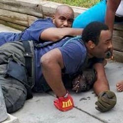 Two Washington, D.C., firefighters hold down two dogs that began attacking civilians at a fire scene Thursday. Two Washington, D.C., firefighters hold down two dogs that began attacking civilians at a fire scene Thursday.