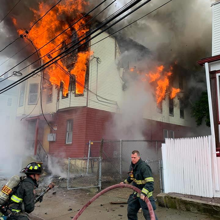 New Bedford, MA, firefighters work to put out a two-alarm blaze that broke out at a vacant three-story building Friday.