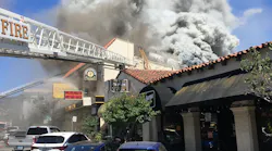 Oakland, CA, firefighters rescued two workers from the roof of a three-alarm blaze that broke out at a commercial building in the city's Glenview neighborhood Monday.