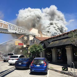 Oakland, CA, firefighters rescued two workers from the roof of a three-alarm blaze that broke out at a commercial building in the city's Glenview neighborhood Monday. Oakland, CA, firefighters rescued two workers from the roof of a three-alarm blaze that broke out at a commercial building in the city's Glenview neighborhood Monday.