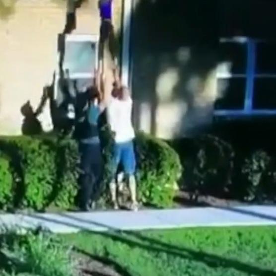 Secaucus, NY, police officers catch a boy, 4, who was dropped from the second-story window of a burning apartment Wednesday.