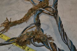 During testing in a laboratory, this new wire rope failed explosively. Not only did the strands come apart, but the fiber core of the rope frayed and is visible. The certificate of testing shows that failure for this 5/8-inch diameter EIPS fiber core wire rope occurred at 37,117 lbs. of pull.