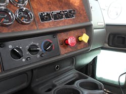 Commercial vehicles utilize pneumatic control systems for various devices that are on the truck. The controls on the dashboard area of this vehicle include the yellow parking brake valve and the red trailer brake valve. Above those are the shift differential switch (axle interlock), air suspension switch and the power take-off (PTO) control switch.