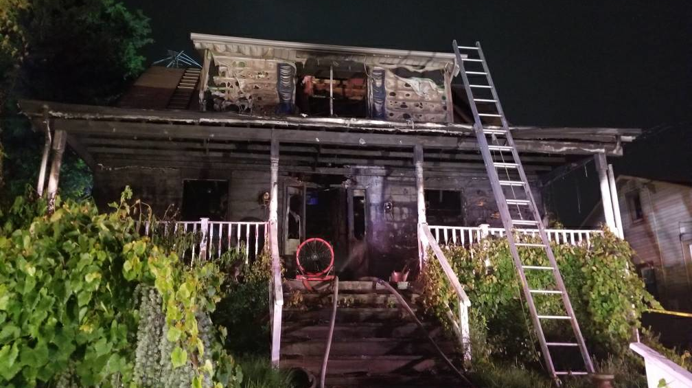 A Baltimore County firefighter suffered minor injures in a house blaze early Tuesday that also critically injured a woman who crews rescued.