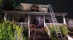 A Baltimore County firefighter suffered minor injures in a house blaze early Tuesday that also critically injured a woman who crews rescued.