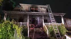 A Baltimore County firefighter suffered minor injures in a house blaze early Tuesday that also critically injured a woman who crews rescued.