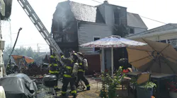 Chicago firefighters battled an extra-alarm blaze that damaged at least four buildings in the Belmont Central neighborhood Wednesday.