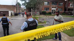 Chicago police secure the scene of a shooting in the Auburn Gresham neighborhood Tuesday. At least 14 people were taken to area hospitals after gunfire was exchanged outside of a funeral home.
